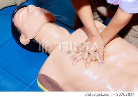 hand student Heart pump with medical dummy on CPR 50762034