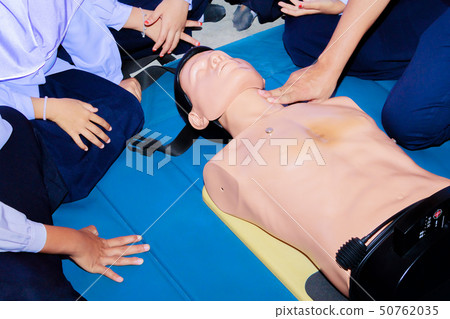 hand student Heart pump with medical dummy on CPR 50762035