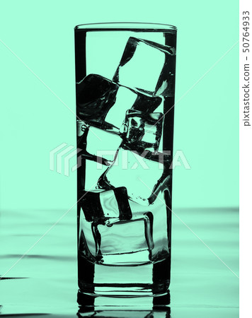 Glass of water with ice cubes. Toned 50764933