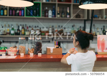 attractive woman makes an order in a cafe attractive woman makes an order in a cafe 50766054