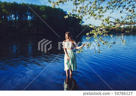 woman smiling in the spring time woman smiling in the spring time 50766127