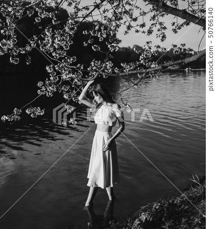 woman in a spring Park in the water 50766140