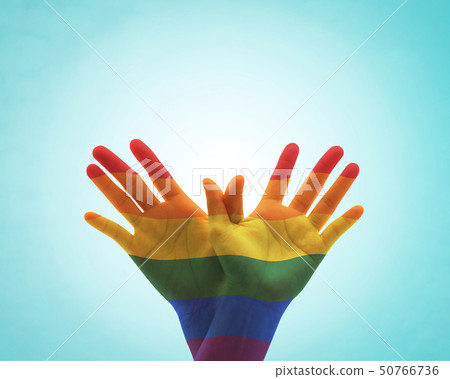 Zero discrimination day with rainbow flag on hands Zero discrimination day with rainbow flag on hands 50766736