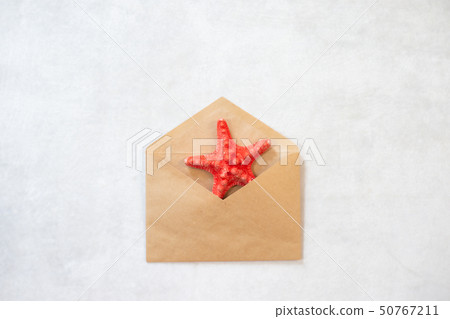 Blank beige envelope and starfish on white background 50767211