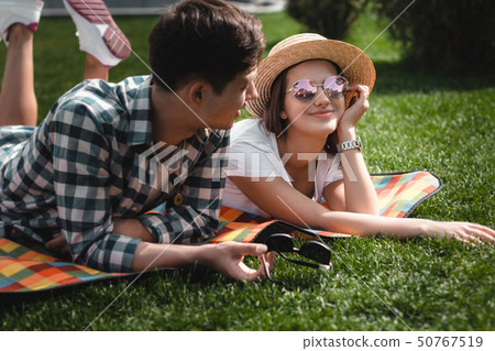 Teens Boy Ang Girl Laying On The Blanket In The Park. Teens Boy Ang Girl Laying On The Blanket In The Park. 50767519