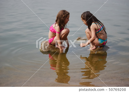 cute happy little girls in sumer lake 50769208