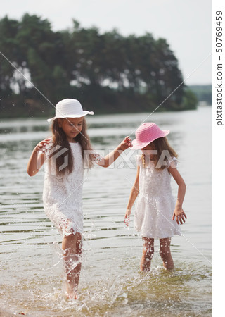 cute happy little girls in sumer lake 50769459