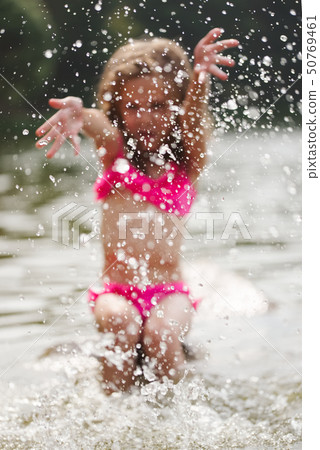 cute happy little girls in sumer lake cute happy little girls in sumer lake 50769461