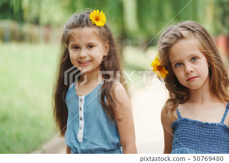 photo of two little girls in summer park photo of two little girls in summer park 50769480