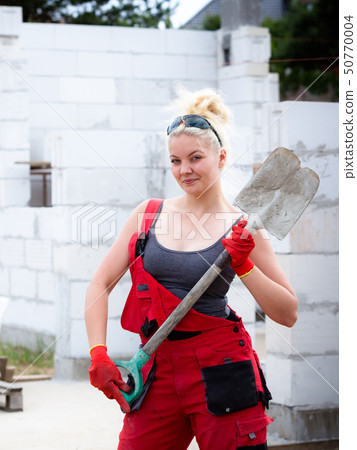 Person using shovel on construction site Person using shovel on construction site 50770004