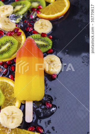 Fruit ice cream on stick with slices fruits  50770617