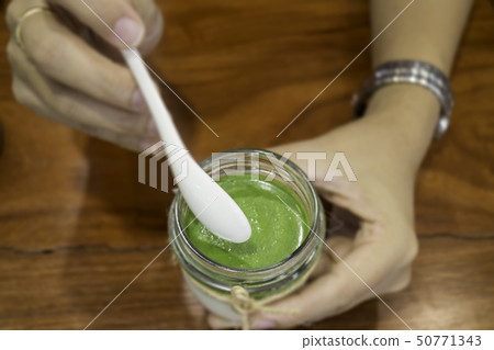 Hand on matcha green tea mousse dessert Hand on matcha green tea mousse dessert 50771343