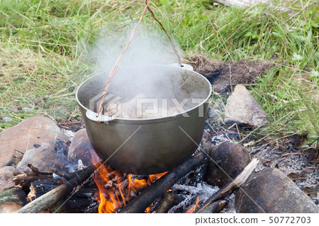 tourist kettle with the cooked food over the 50772703