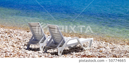 Two deck chairs on beach in sunny autumn day Two deck chairs on beach in sunny autumn day 50774665