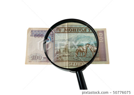 Mongolian tugriks bill and magnifying glass Mongolian tugriks bill and magnifying glass 50776075