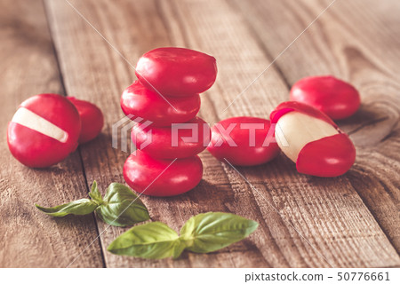 Small snack cheeses on the wooden board 50776661