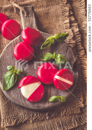 Small snack cheeses on the wooden board 50776663