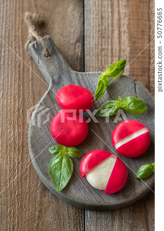 Small snack cheeses on the wooden board 50776665