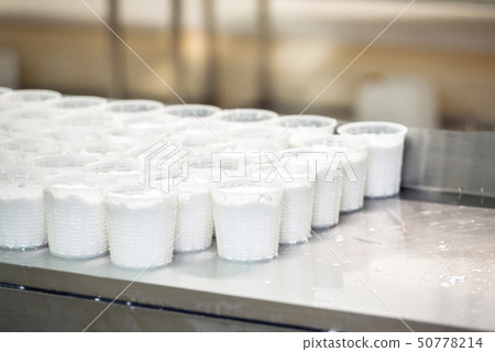 Close up view on many freshly made cottage cheese in plastic package 50778214