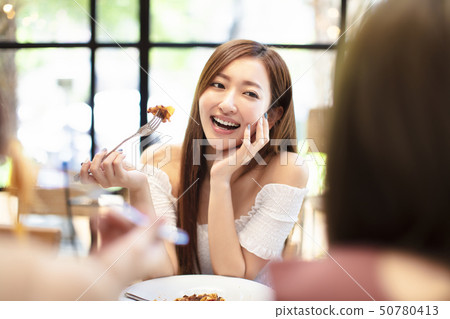 young woman with friends having dinner in the young woman with friends having dinner in the 50780413