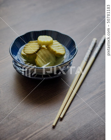 Cucumber pickles and chopsticks 50781183