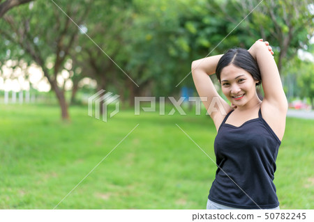 Young female warm up before exercise at the park 50782245