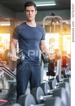 Handsome weightlifter lifting bench press working 50782697