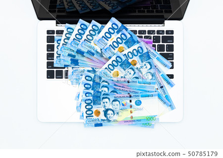 Philippine peso bill with laptop computer. Philippine peso bill with laptop computer. 50785179