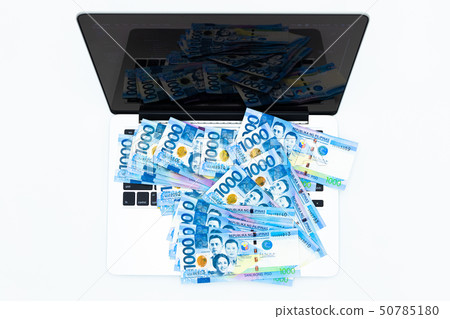Philippine peso bill with laptop computer. Philippine peso bill with laptop computer. 50785180
