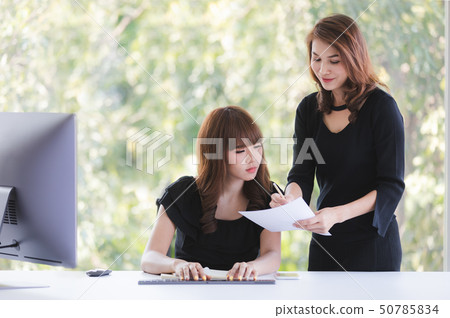 TWO BUSINESS LADIES IN OFFICE 50785834