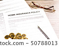Home Insurance Policy. Pen, Glasses and Coins on Table 50788013