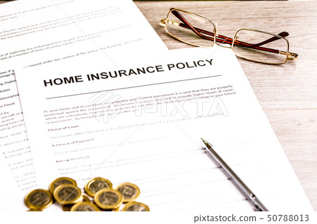 Home Insurance Policy. Pen, Glasses and Coins on Table Home Insurance Policy. Pen, Glasses and Coins on Table 50788013