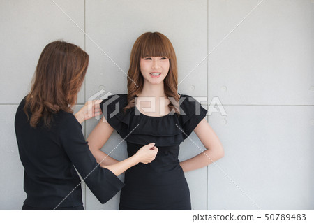 Young lady in black dress Young lady in black dress 50789483