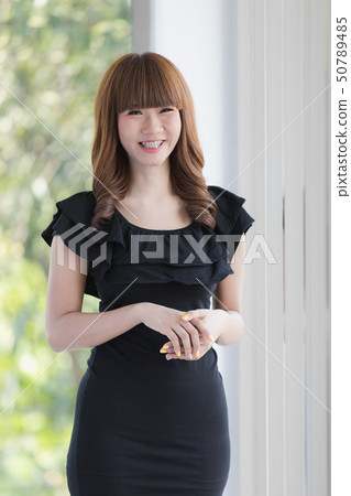 Young lady in black dress 50789485