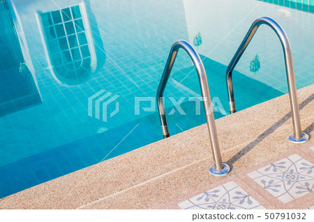 Grab bars ladder with blue water Grab bars ladder with blue water 50791032