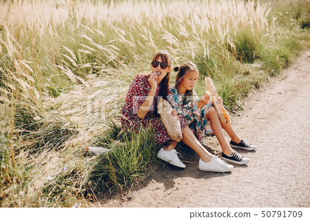 Cute and stylish family in a summer field Cute and stylish family in a summer field 50791709