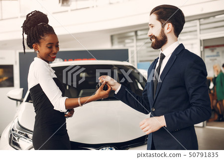 Elegant couple in a car salon Elegant couple in a car salon 50791835