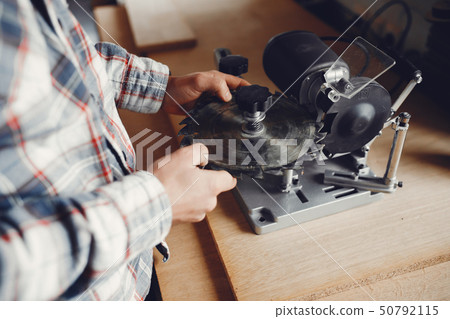 The carpenter works with a tree 50792115