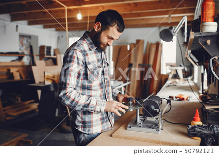 The carpenter works with a tree 50792121