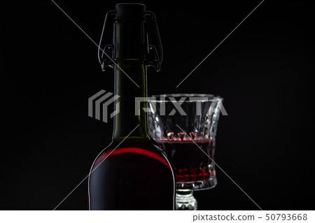 Rose wine. Red wine in bottle with wine glass over dark background. Silhouette Rose wine. Red wine in bottle with wine glass over dark background. Silhouette 50793668