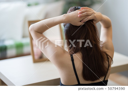Woman looking in the mirror Woman looking in the mirror 50794390