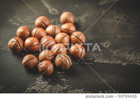 Macadamia nuts on wooden table Macadamia nuts on wooden table 50795430