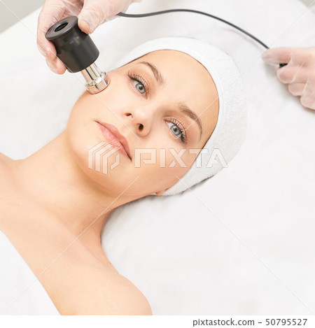 Electroporation woman face treatment. Facial 50795527