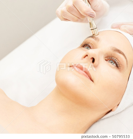 Cosmetology face treatment. Patient young girl. 50795533