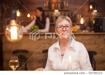 Portrait of elderly woman in a vintage restaurant 50796525