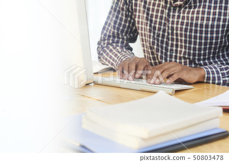 Man working or studying on computer Man working or studying on computer 50803478