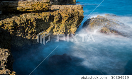 Sea waves are beating against the rocky shore Sea waves are beating against the rocky shore 50804919