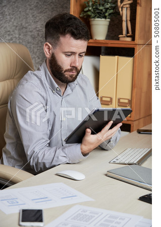 Businessman working on digital tablet Businessman working on digital tablet 50805001