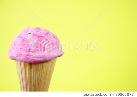 Strawberry ice-cream scoop in waffle cone  50805878