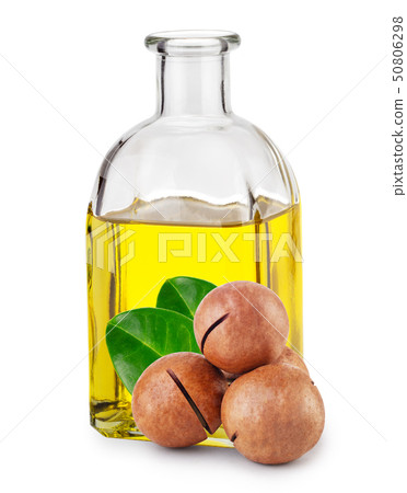 Macadamia oil in bottle and nuts with leaves Macadamia oil in bottle and nuts with leaves 50806298